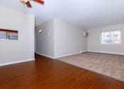 Thumbnail 12 of 25 - a bedroom with hardwood floors and a ceiling fan