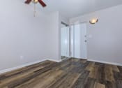 Thumbnail 18 of 25 - a bedroom with hardwood flooring and a ceiling fan