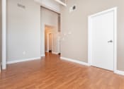 Thumbnail 36 of 58 - a living room and hallway with wood flooring and a white door