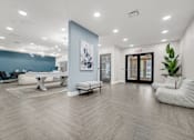 Thumbnail 37 of 44 - A spacious room with a blue accent wall and a white chair. at Park Lamont Townhomes Apartments, Ohio, 44106