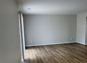 Thumbnail 18 of 18 - A room with wooden flooring and white walls.