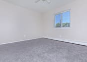 Thumbnail 13 of 23 - a bedroom with gray carpet and white walls
