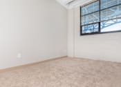 Thumbnail 41 of 58 - an empty living room with white walls and a window