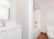 Thumbnail 44 of 58 - a bathroom with a toilet sink and tub and a mirror