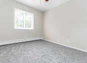 Thumbnail 9 of 23 - a bedroom with gray walls and a white window