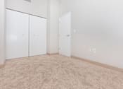 Thumbnail 42 of 58 - a room with carpet and white walls and doors