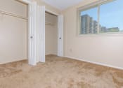 Thumbnail 43 of 43 - Standard unit master bedroom with carpeting and double closets  at 444 Park Apartments, Ohio, 44143