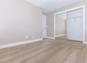 Thumbnail 17 of 31 - an empty bedroom with a closet and a mirror