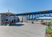 Thumbnail 54 of 58 - the deck has a picnic table and a gazebo and a blue bridge