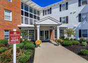Thumbnail 20 of 31 - a walkway leading to a building with a sign that reads westfield leasing office