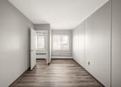 Thumbnail 23 of 48 - an empty room with white walls and a wood floor
