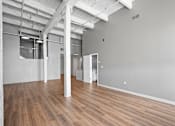 Thumbnail 8 of 58 - A large empty room with wooden floors and white walls.