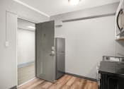 Thumbnail 26 of 48 - a kitchen with a stainless steel refrigerator and a glass door
