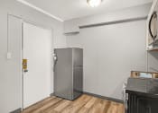 Thumbnail 27 of 48 - a kitchen with a refrigerator and a stove and a door