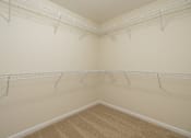 Thumbnail 10 of 27 - Empty room with white walls and a carpeted floor.