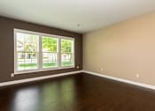 Thumbnail 8 of 27 - A room with a large window and wooden flooring.