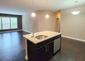 Thumbnail 6 of 27 - A kitchen with a sink and cabinets.