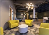 Thumbnail 27 of 28 - a large room with yellow chairs and grey chairs