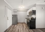 Thumbnail 15 of 48 - a kitchen with white cabinets and a black stove and refrigerator