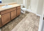 Thumbnail 27 of 27 - A bathroom with a sink, toilet, and shower.
