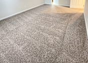 Thumbnail 24 of 27 - A room with a ceiling fan and carpeted floor.