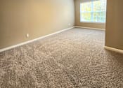 Thumbnail 17 of 27 - A room with a ceiling fan and carpeted floor.