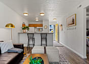 Thumbnail 2 of 19 - A living room with a brown leather couch and a gold floor lamp. at Vivo Toledo Apartments, Toledo, OH
