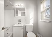 Thumbnail 29 of 48 - a bathroom with a toilet sink and a mirror