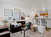Thumbnail 1 of 19 - A living room with a brown couch, a coffee table, and a striped pillow. at Vivo Toledo Apartments, Toledo, OH, 43607