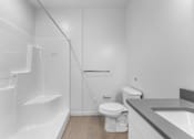 Thumbnail 9 of 61 - A white bathroom with a toilet, sink, and bathtub.