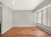 Thumbnail 36 of 48 - an empty living room with wood flooring and a large window