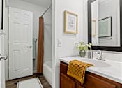 Thumbnail 6 of 19 - A bathroom with a white sink and a yellow towel. at Vivo Toledo Apartments, Ohio