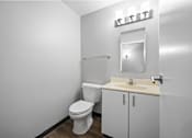Thumbnail 18 of 58 - A white bathroom with a toilet, sink, and mirror.