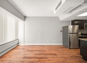 Thumbnail 37 of 48 - an empty kitchen with a stainless steel refrigerator and a window