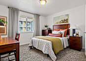 Thumbnail 4 of 19 - A bedroom with a bed, nightstand, and chair. at Vivo Toledo Apartments, Toledo, Ohio