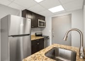 Thumbnail 34 of 48 - a kitchen with stainless steel appliances and granite counter tops
