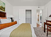 Thumbnail 5 of 19 - A bedroom with a bed, a chair, and a painting on the wall. at Vivo Toledo Apartments, Toledo