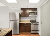 Thumbnail 31 of 48 - a kitchen with stainless steel appliances and wooden cabinets