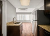 Thumbnail 33 of 48 - an empty kitchen with a sink and a refrigerator