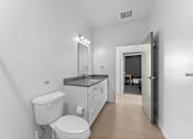 Thumbnail 14 of 61 - A white bathroom with a toilet, sink, and mirror.