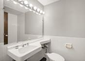 Thumbnail 38 of 48 - a bathroom with a sink and a toilet and a mirror