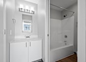 Thumbnail 33 of 58 - A white bathroom with a glass shower stall and a window.