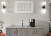 Thumbnail 4 of 48 - a cupboard with a coffee maker and a tablet on it in a living room