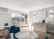 Thumbnail 5 of 48 - a living room with a table and chairs and a large window