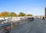 Thumbnail 49 of 61 - A wooden deck with chairs and a table.