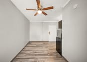 Thumbnail 18 of 48 - a living room with white walls and a ceiling fan