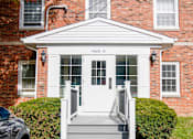 Thumbnail 30 of 31 - the front of a red brick building with white steps and a white door