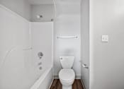 Thumbnail 27 of 58 - A white bathroom with a toilet, tub, and shower.