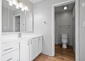 Thumbnail 12 of 58 - A white bathroom with a toilet and a sink.