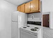 Thumbnail 2 of 12 - A white refrigerator and stove in a kitchen.